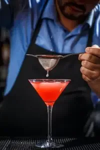 barman-makes-cosmopolitan-cocktail-200x300.webp